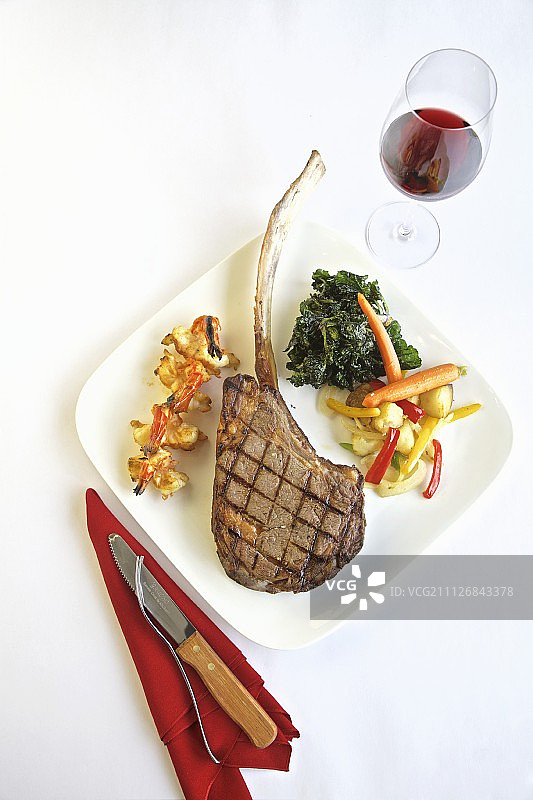 烤战斧牛排配配菜和一杯红酒(从上面看)图片素材
