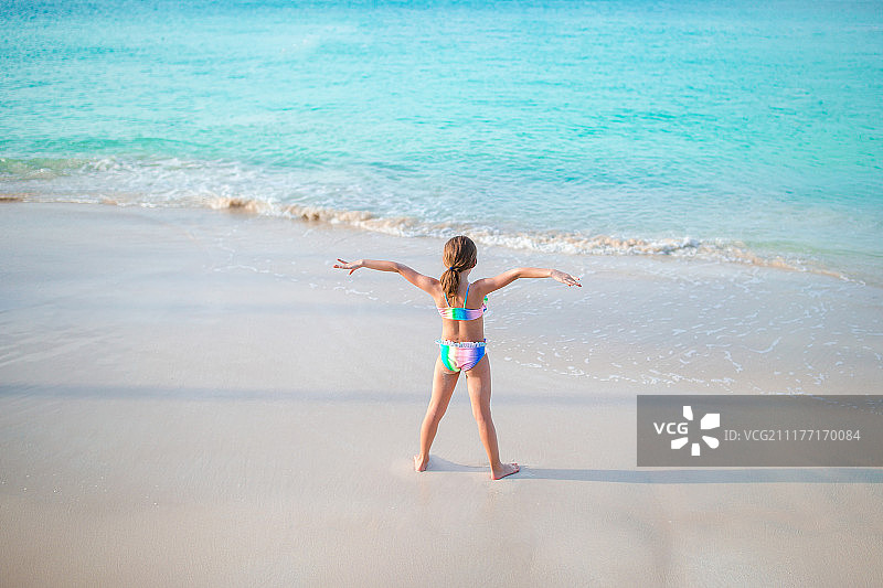 加勒比海度假时海滩上的可爱小女孩图片素材