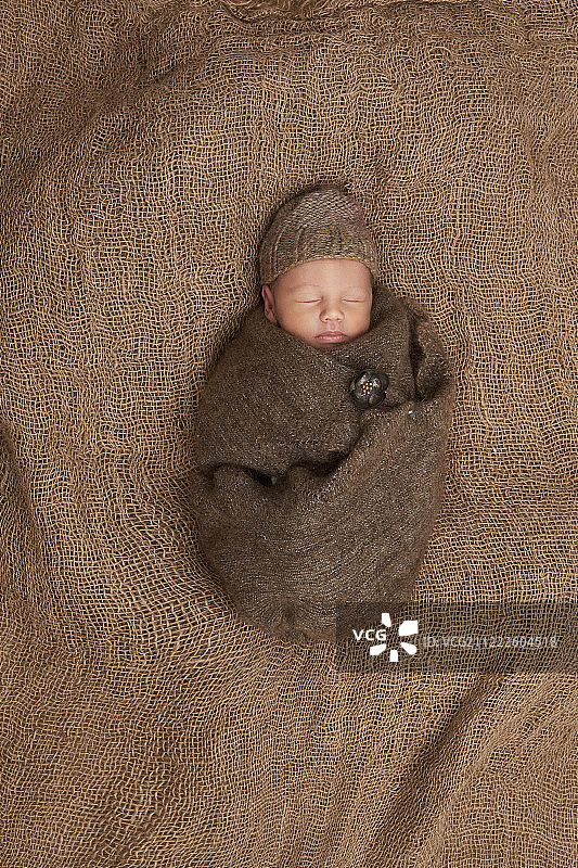 新生儿睡在麻袋布，肖像，花，棕色图片素材