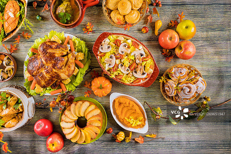 感恩节晚餐平铺着烤火鸡、红薯和肉桂卷图片素材