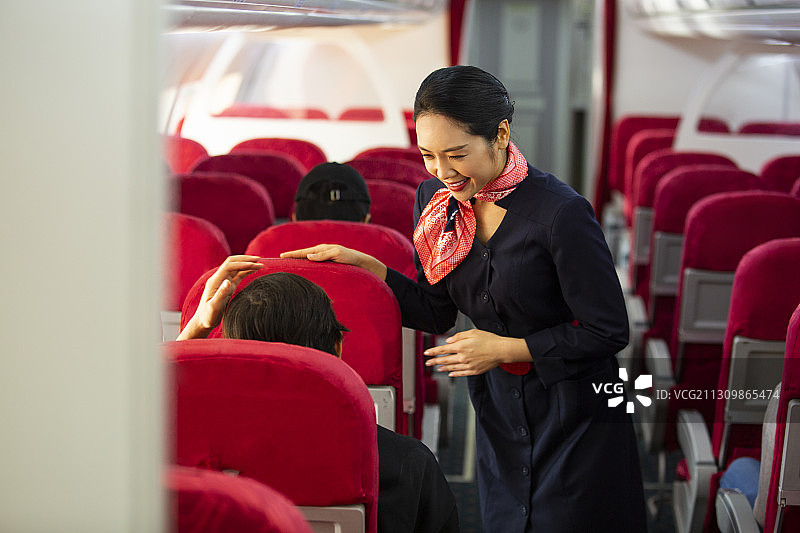 空姐在飞机机舱工作与乘客沟通交流图片素材
