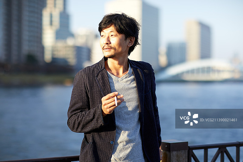 日本男子在户外吸烟图片素材