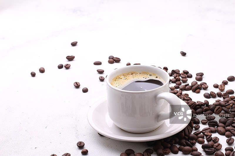 高角度的咖啡杯与豆在桌子上，贝卡西，印度尼西亚图片素材