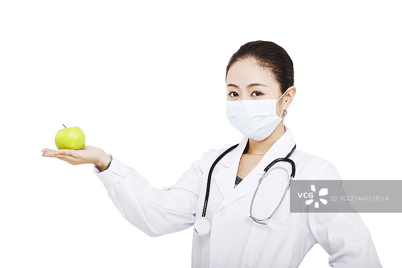 东方年轻女医生拿着一个青苹果图片素材