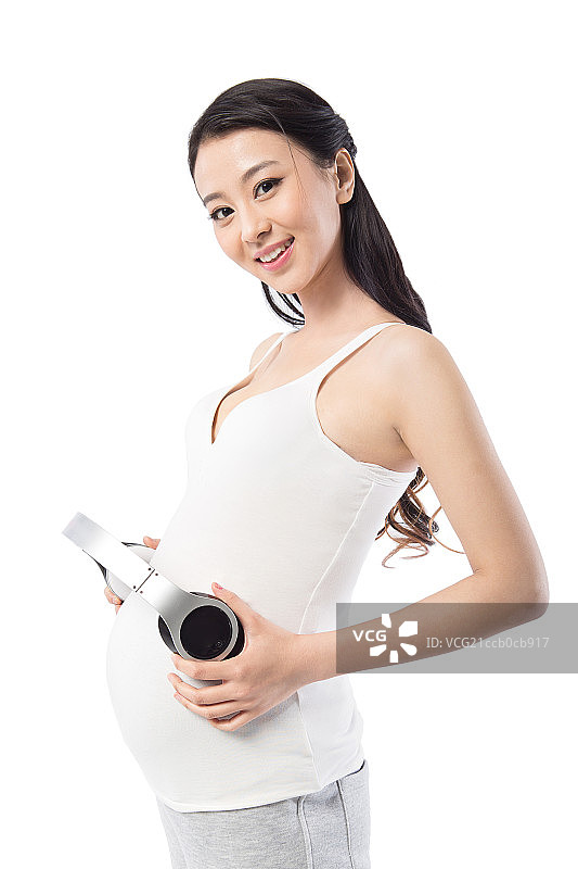 手拿耳机的孕妇图片素材