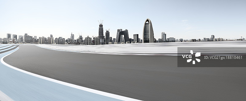 逆光下的北京CBD摩天大楼远景和蜿蜒的F1赛道速度特效图片素材