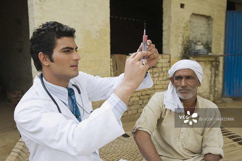 医生正在给印度哈里亚纳邦哈桑普尔的一位农民打针图片素材