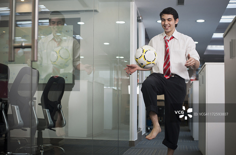 在办公室玩足球的商人图片素材
