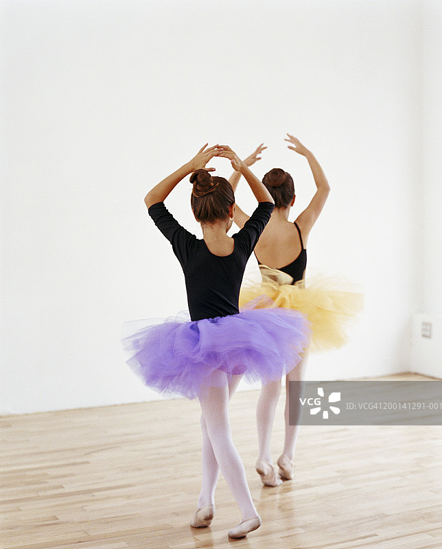 年轻芭蕾舞者(7-10岁)在芭蕾舞团做脚尖旋转图片素材