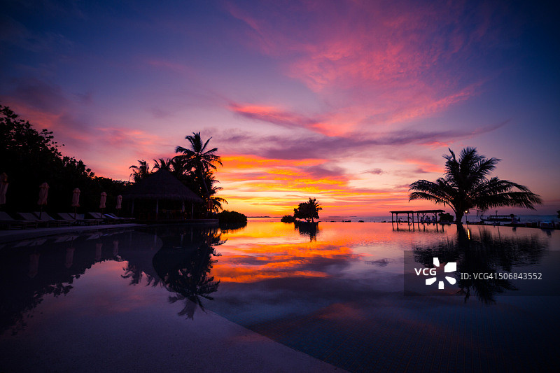 马尔代夫岛的日落，倒影在游泳池图片素材