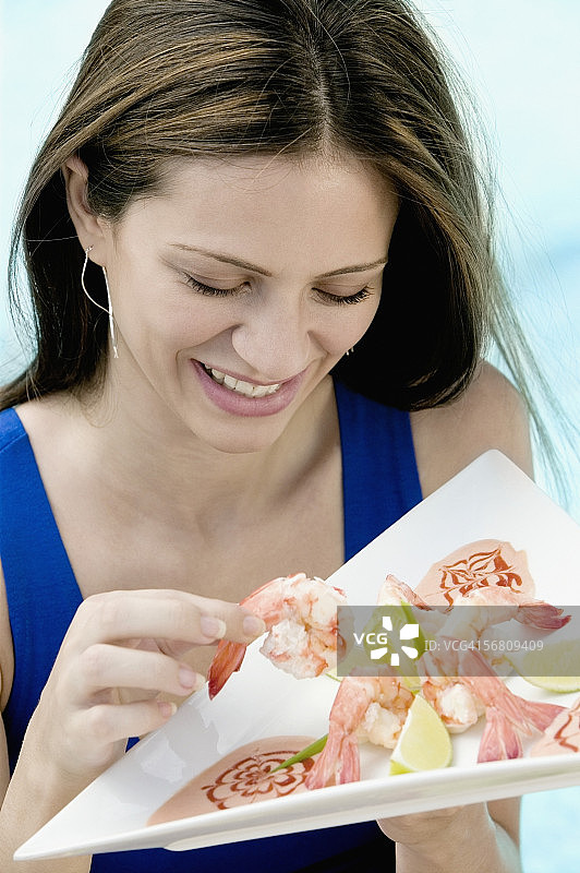 高角度的一个年轻女人拿着食物在一个托盘图片素材