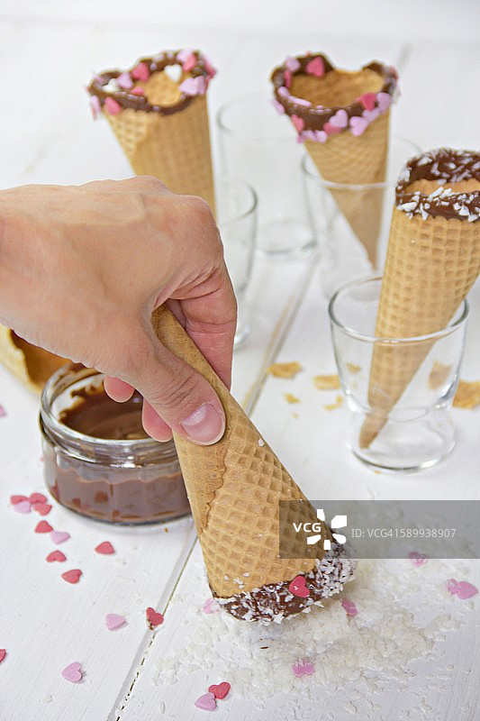 甜筒冰淇淋，巧克力，心形糖，用手蘸椰子片图片素材