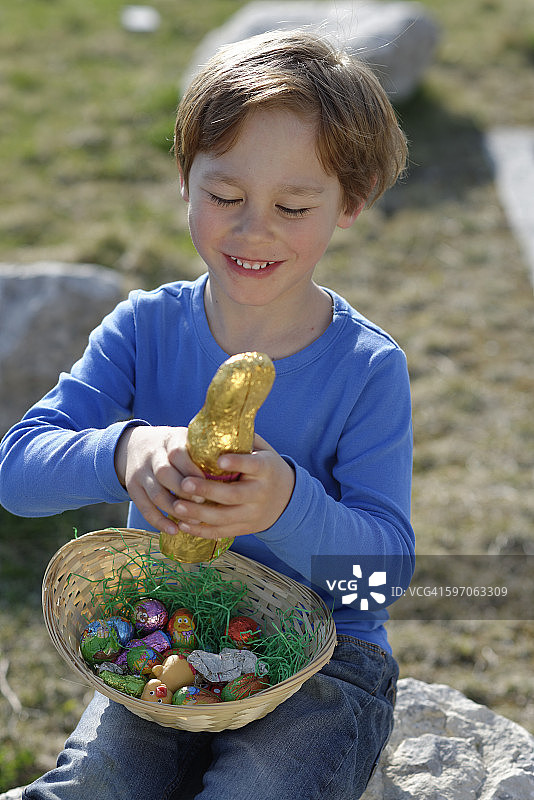 微笑的小男孩的肖像复活节窝和复活节兔子图片素材