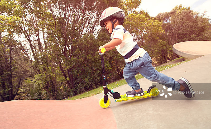 滑板公园里骑着滑板车的孩子。图片素材