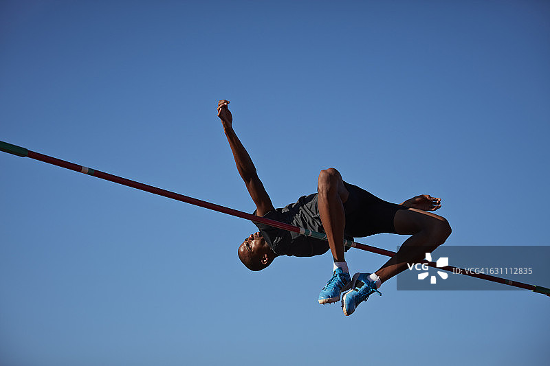 男运动员在日落时跳高图片素材