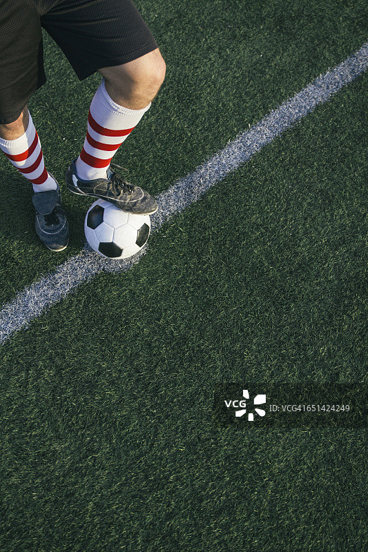 足球运动员的腿在足球场上图片素材