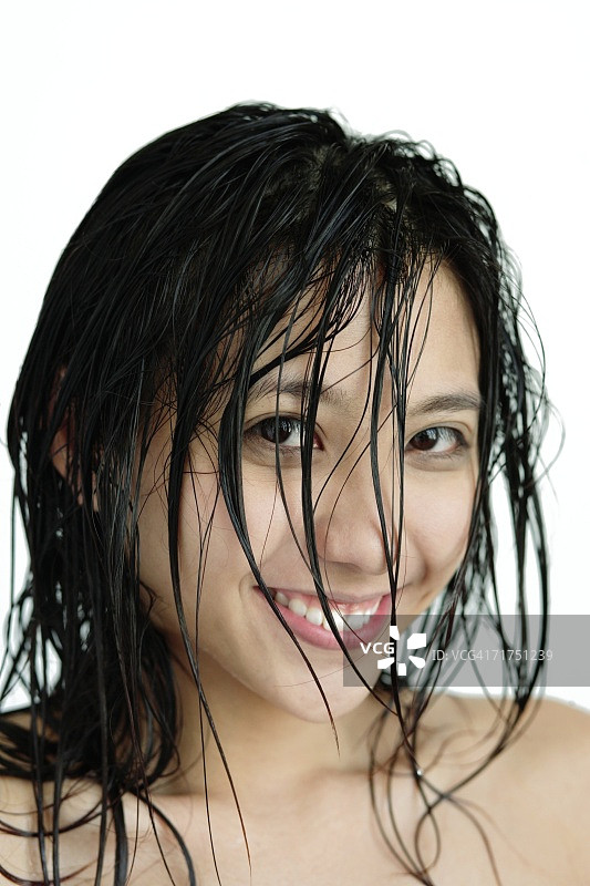 头发湿了的女人，对着镜头微笑图片素材