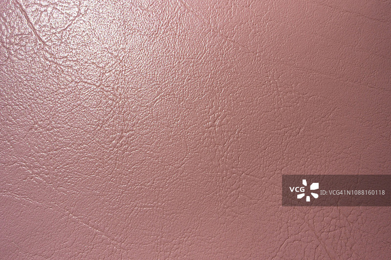 粗糙表面的粉红色真皮抽象背景复古。图片素材
