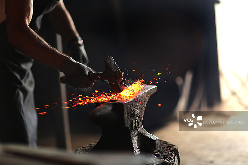 铁匠手工锻造熔化的金属图片素材