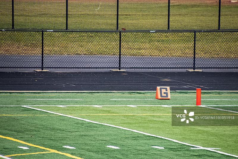 高中体育馆美式足球场上橙色的目标标记图片素材
