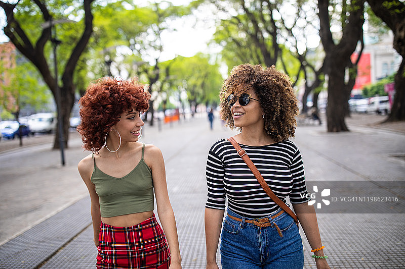 两个时髦的拉丁女人走在城里图片素材