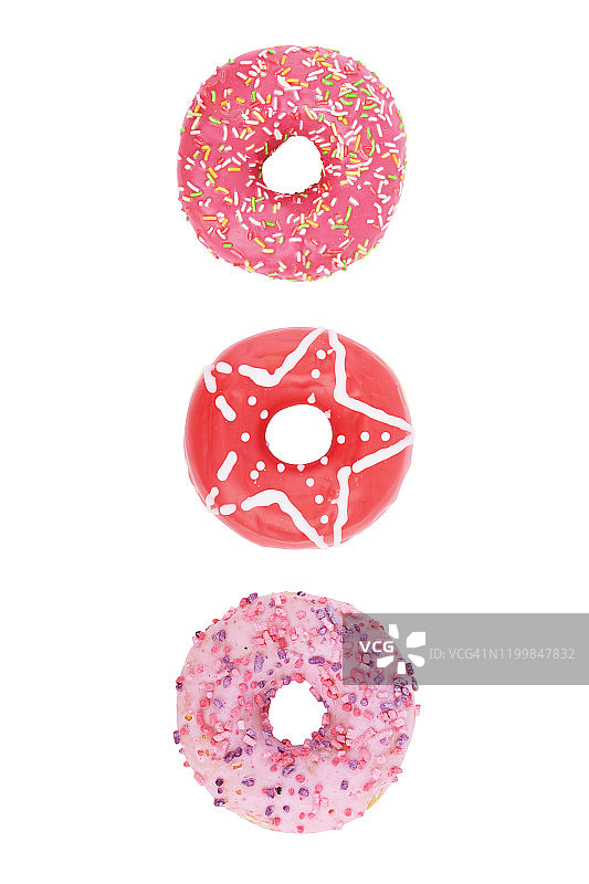 一套甜甜圈与彩色的点缀孤立在白色的背景。正上方的观点。图片素材
