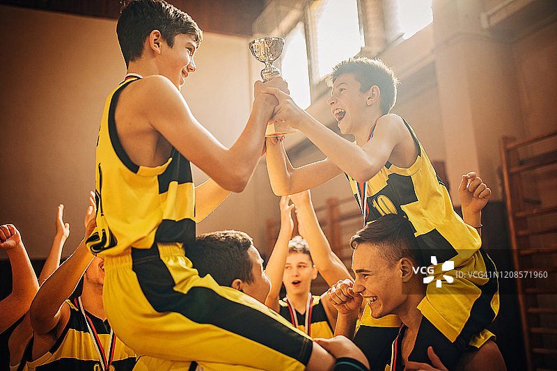 少年篮球队庆祝赢得奖杯图片素材
