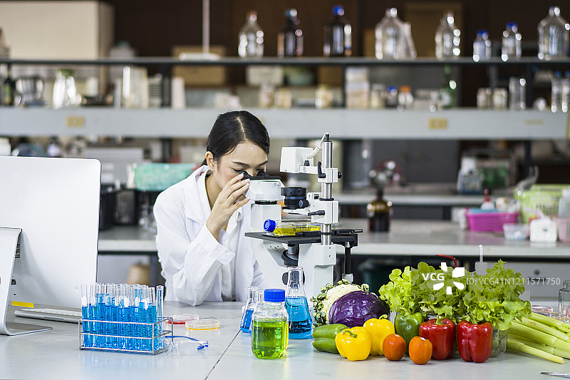女性微生物学家在实验室使用显微镜图片素材