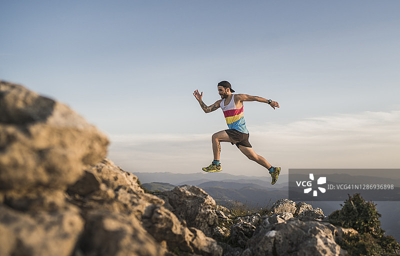 日落时分，运动员在山上奔跑，天空晴朗图片素材