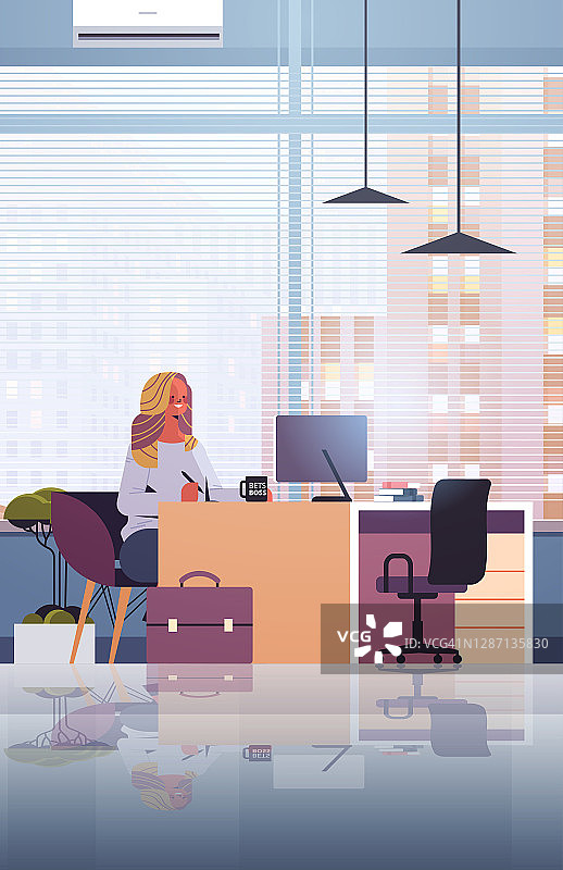 年轻的女商人坐在工作场所和使用电脑女商人在办公室工作图片素材