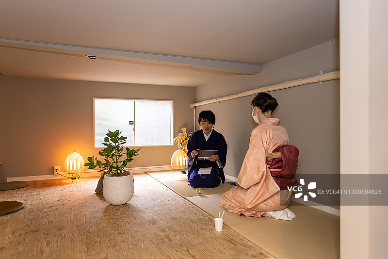 日本妇女和白人妇女在和服坐在榻榻米房间图片素材