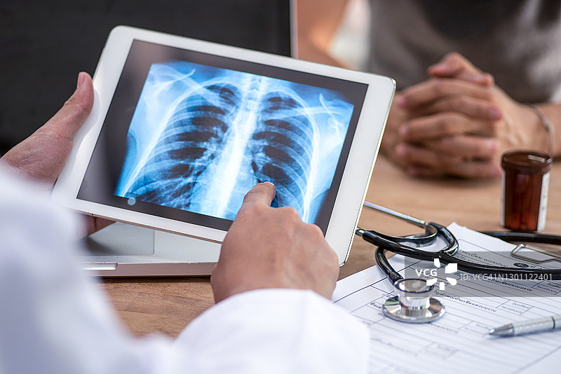 医生在平板电脑上看扫描肺。图片素材