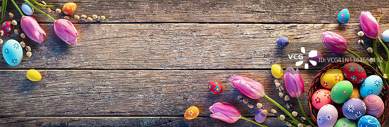 复活节-装饰鸡蛋在篮子里的乡村木板与郁金香图片素材