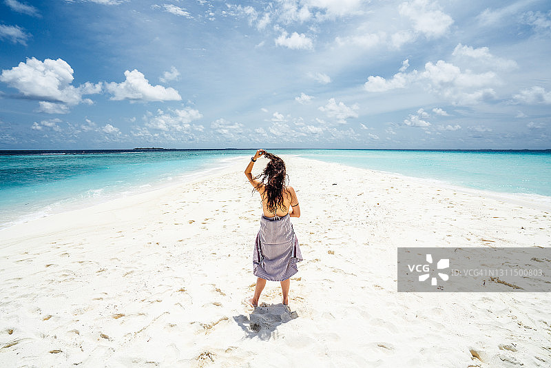 年轻的成年女子在马尔代夫享受天堂般的海滩图片素材