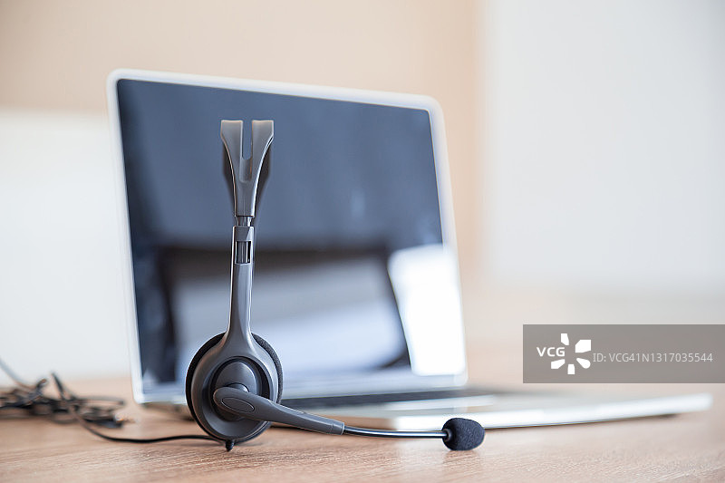 沟通支持，呼叫中心和客户服务帮助台。电话键盘上的VOIP耳机。图片素材