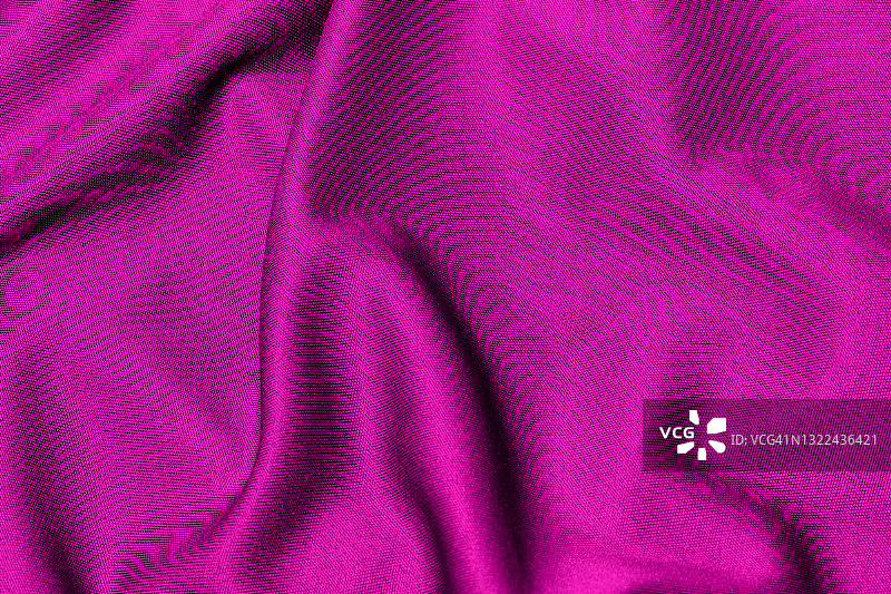 粉红色布料，聚酯质地和纺织背景。图片素材