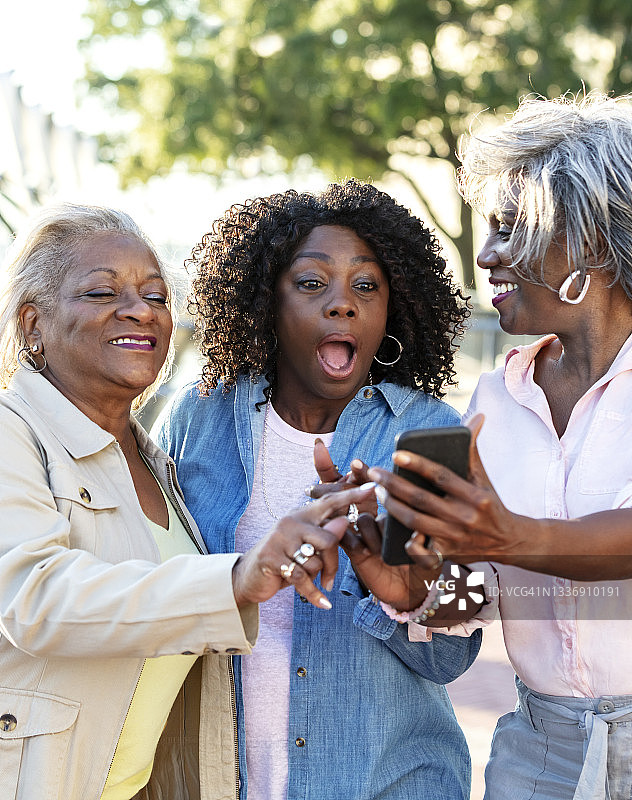资深非裔美国妇女在电话里分享好消息图片素材