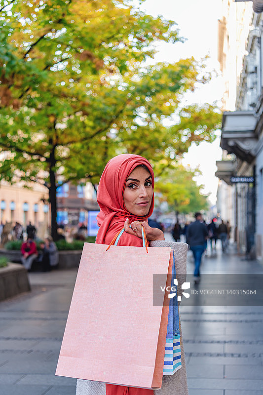 穆斯林妇女在城市里享受购物时光。图片素材