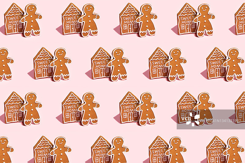 图案姜饼人和房子在粉彩背景。图片素材