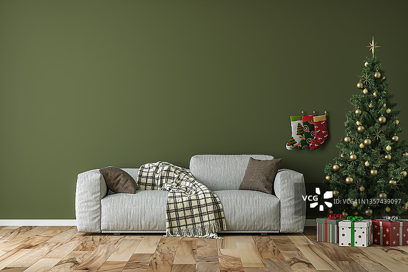 空荡荡的简单客厅里摆放着灰色的沙发、圣诞树和礼物图片素材