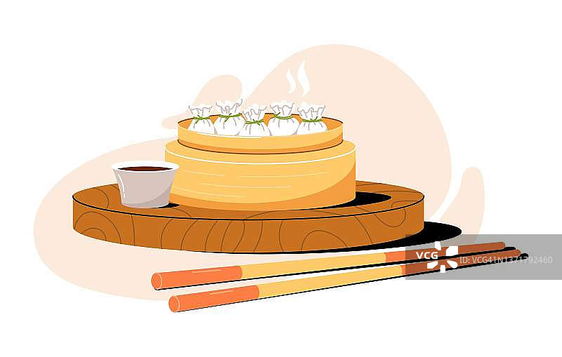 亚洲菜-蒸锅点心，筷子和酱汁。中国的云吞图片素材