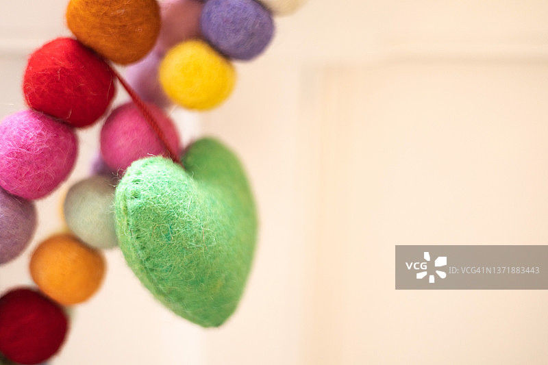 家居装饰带来欢乐:悬挂充满活力的多色彩球彩球和心感弦花环(有副本空间)图片素材