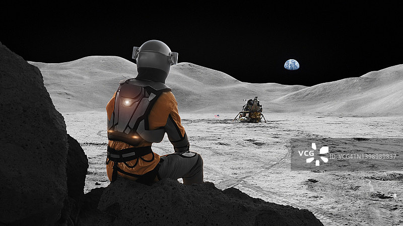 宇航员困在月球上想家。天空中遥远的行星地球图片素材