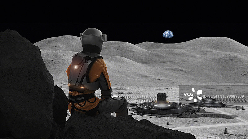 宇航员困在月球上想家。天空中遥远的行星地球图片素材