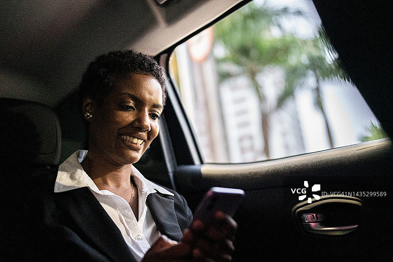 成熟的女人在车里使用手机图片素材