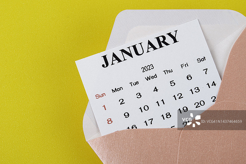 日历台2023:1月是组织者的一个月，用黄色的纸背景计划和截止日期。图片素材