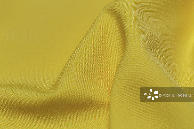 黄色织物布涤纶纹理和纺织背景。图片素材