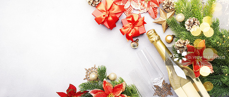 圣诞佳节背景以香槟酒瓶和酒杯为主，红色礼盒图片素材