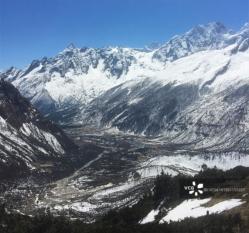 尼泊尔，白雪皑皑的山脉映衬着晴朗的天空图片素材