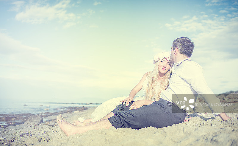 海滩上浪漫的新婚夫妇。图片素材